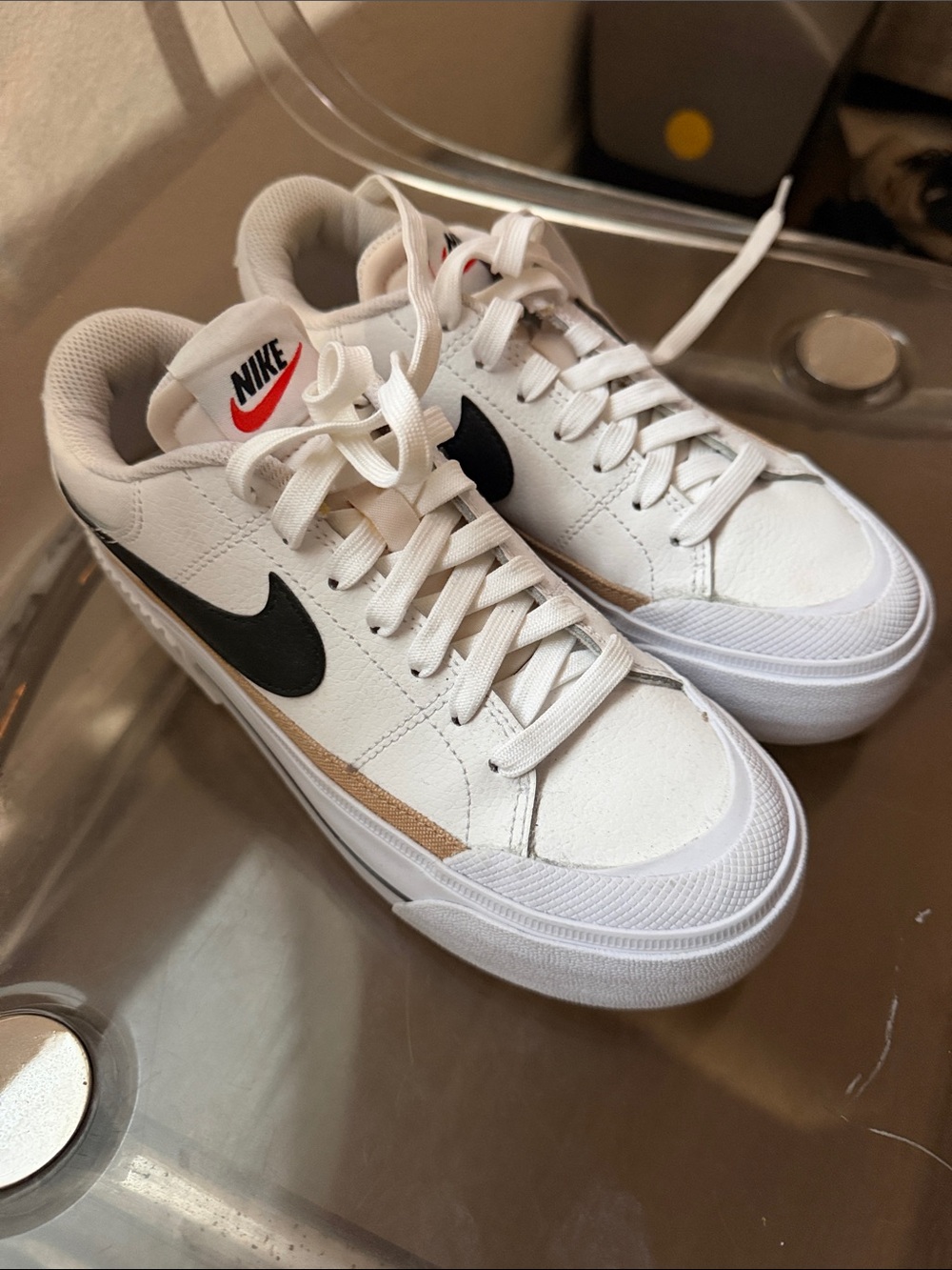 Nike White Low-Top Sneakers with Black Swoosh and Tan Accent